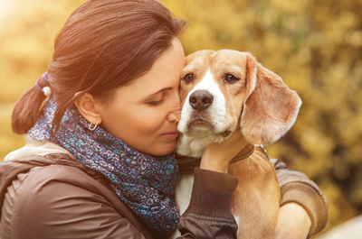 woman saying goodbye to old dog